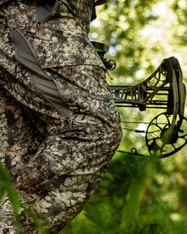 hunter walking in lightweight pants by asio gear in raptor camo