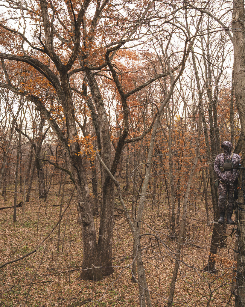 hunter wearing asio gear bowhunting gear walking into woods to hunt during whitetail rut.