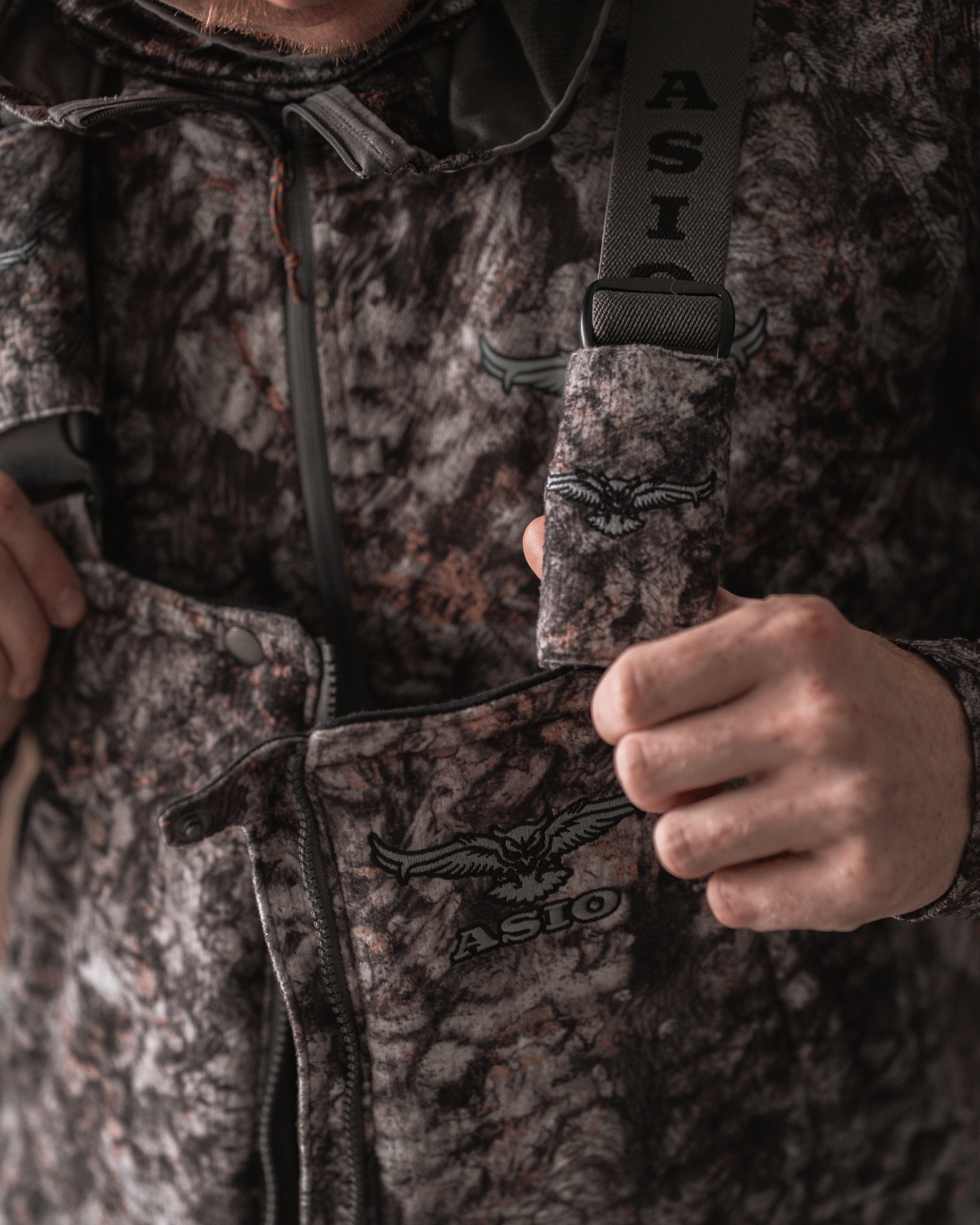 Front chest view of ASIO Heavyweight Bib in RAPTOR camo with logo and dual suspenders visible