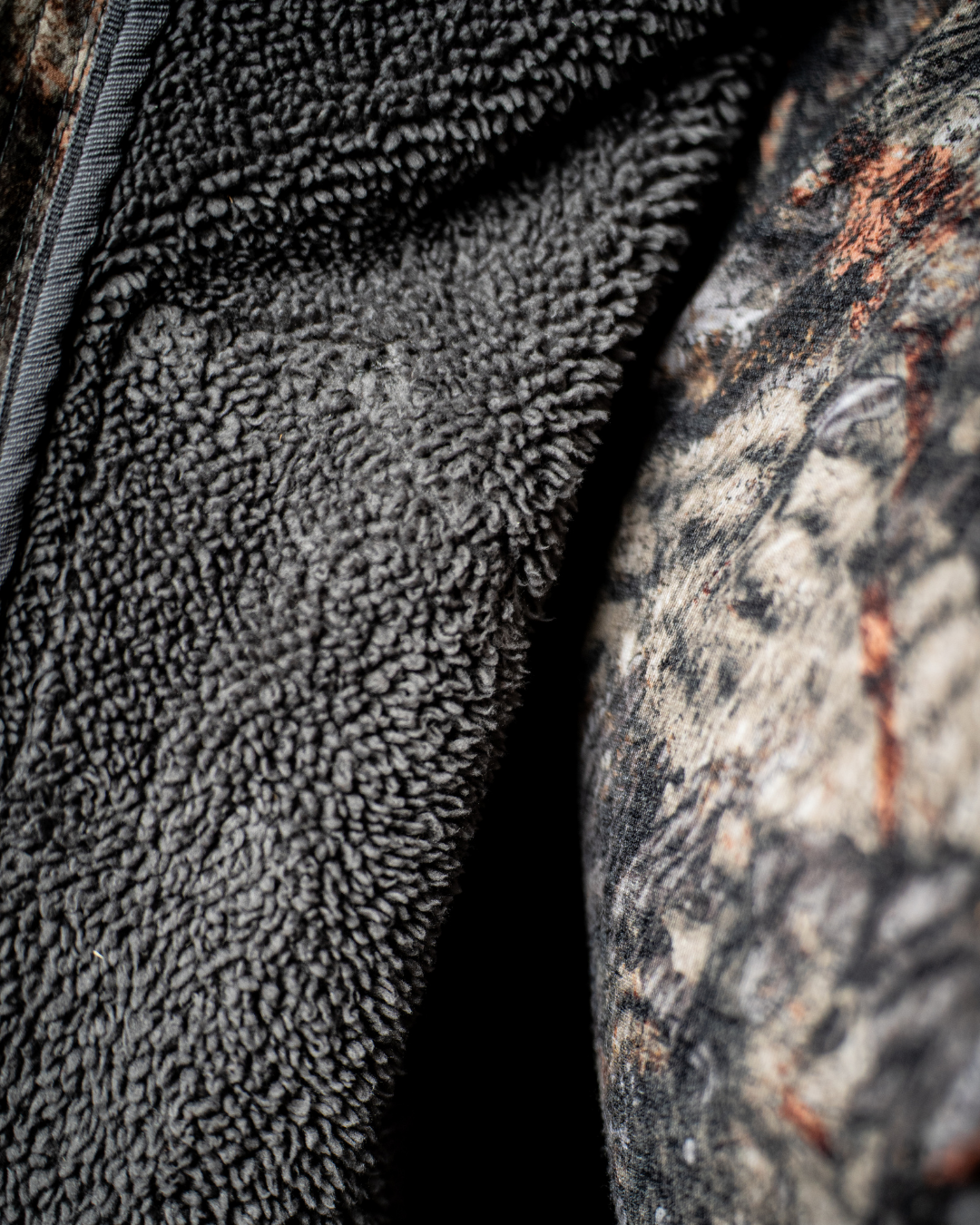 Close up of the ASIO Gear Midweight Sherpa Jacket showing the soft sherpa fleece interior designed for warmth during cold weather bowhunting.