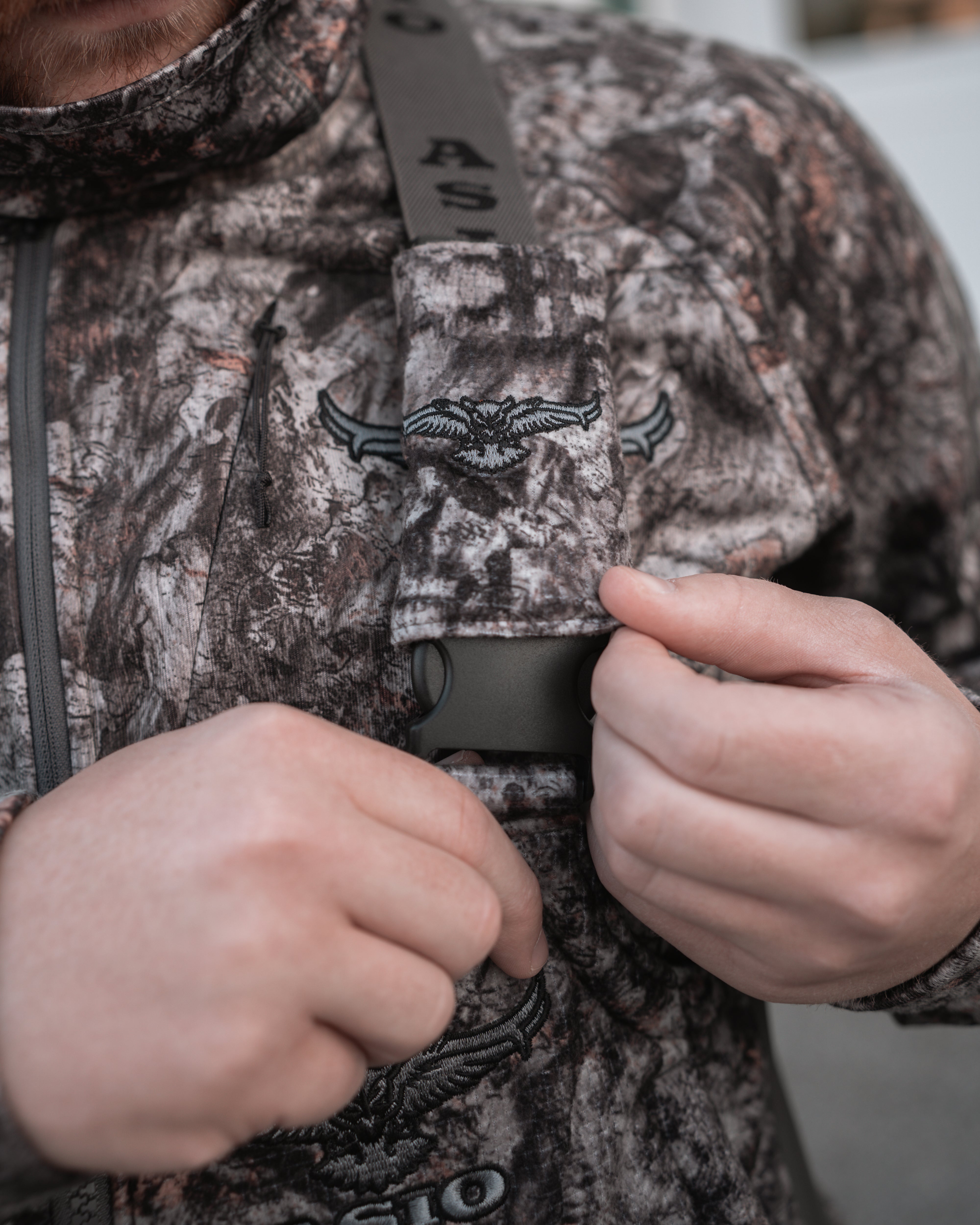 hunter using silent buckle cover on raptor camo midweight sherpa bibs for bowhunting