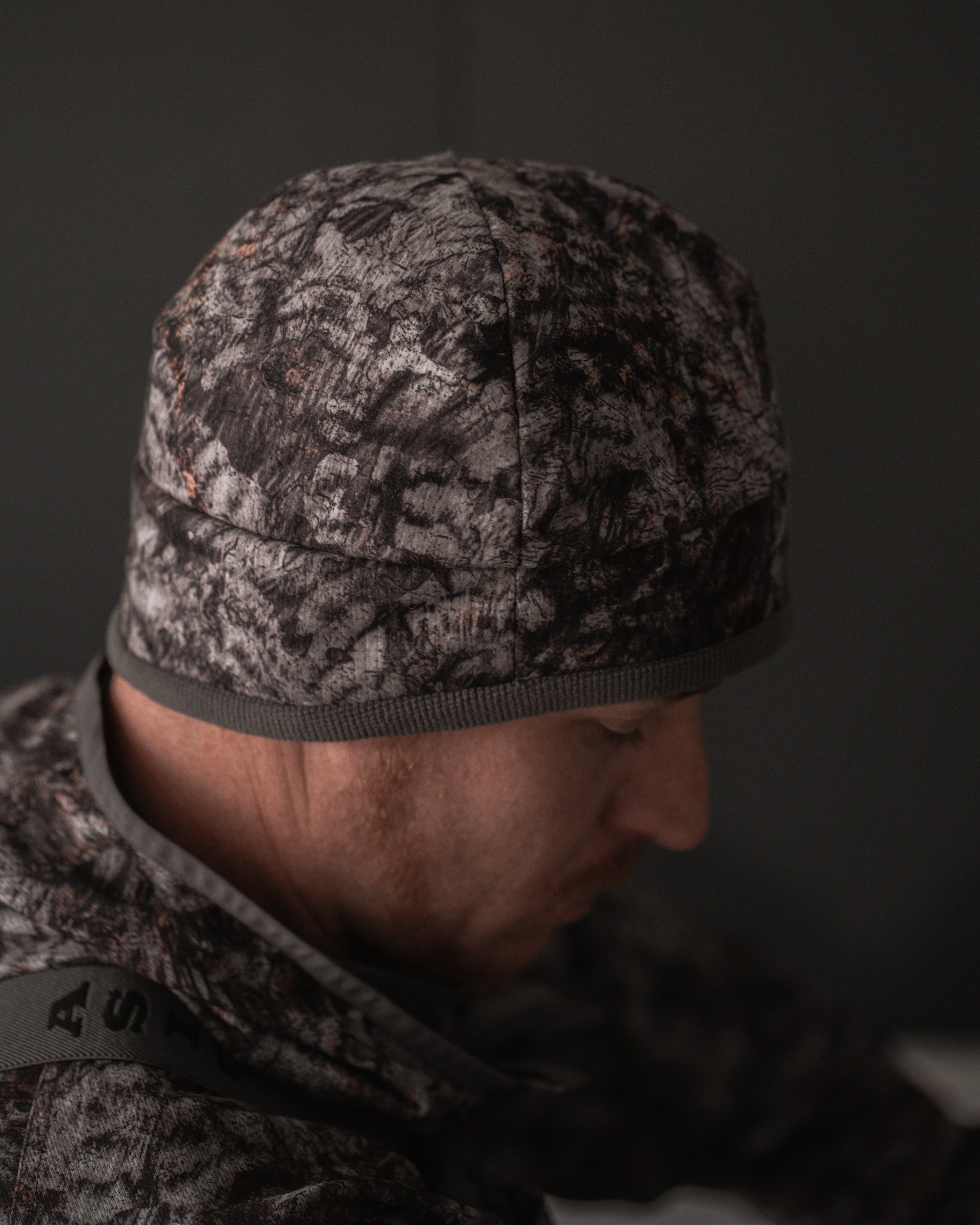 Side view of ASIO Gear 3-layer sherpa-lined beanie in RAPTOR camo with windproof insulation
